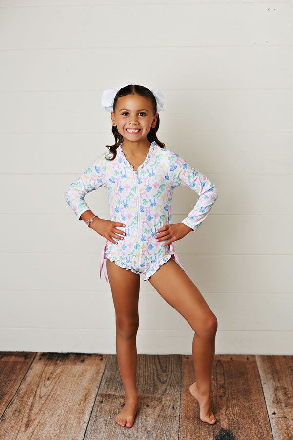 Swoon Baby Bow-tiful UPF 50 Rashguard One Piece Swimsuit