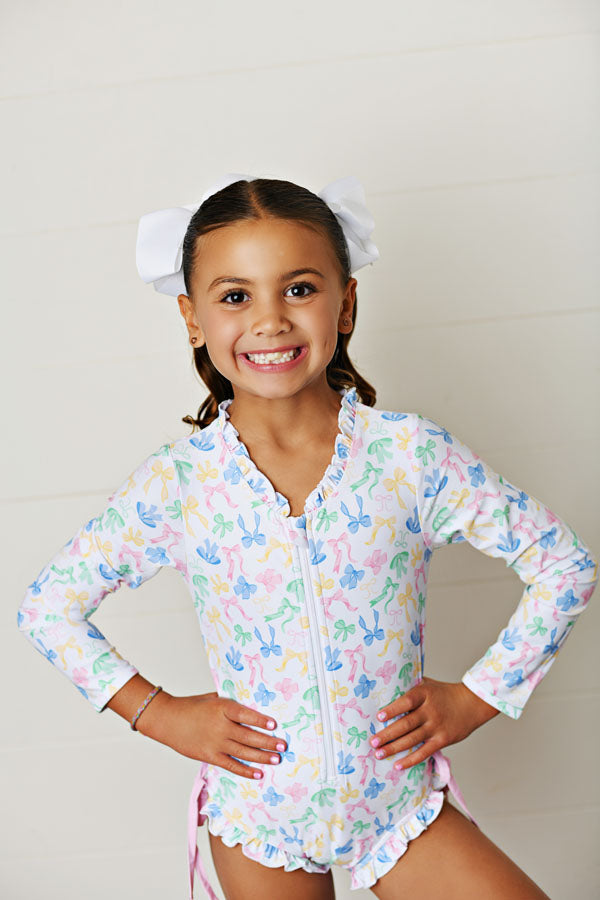 Swoon Baby Bow-tiful UPF 50 Rashguard One Piece Swimsuit